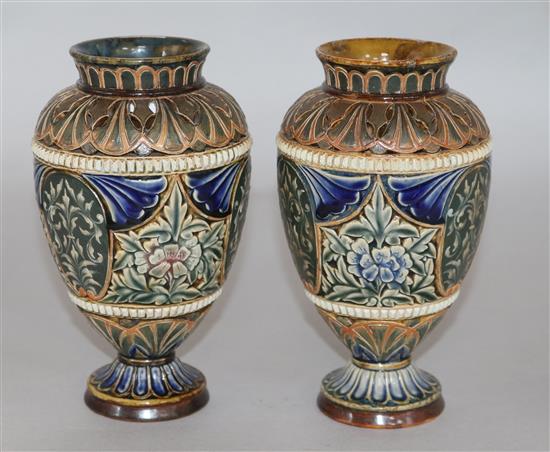A pair of Doulton Lambeth reticulated pate sur pate decorated vases, dated 1883, H.18cm.